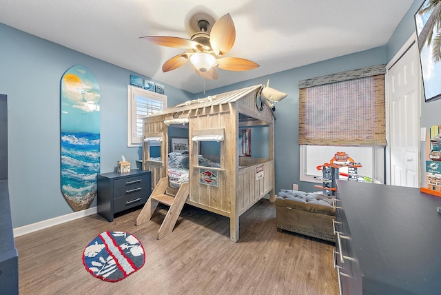 bedroom featuring ceiling fan, a closet, and dark hardwood / wood-style floors