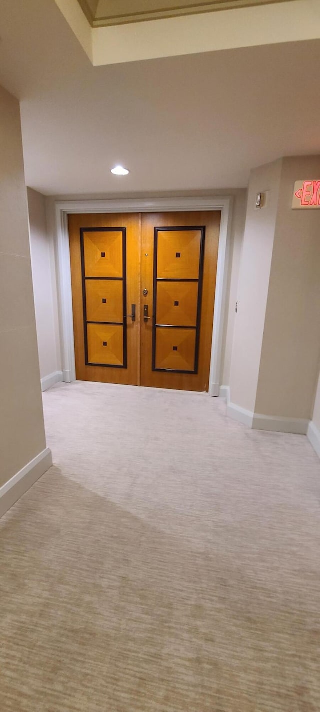 hallway featuring light carpet