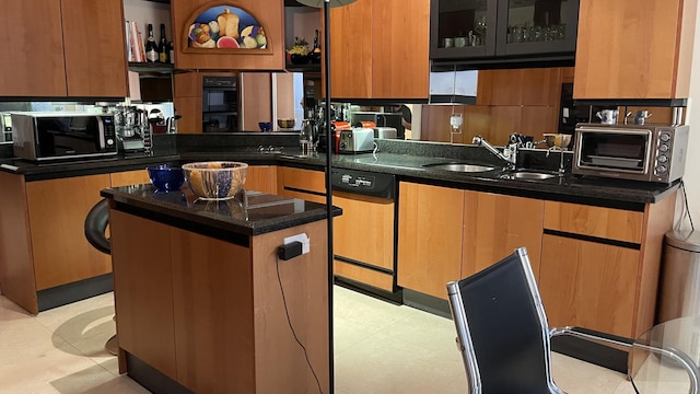 kitchen featuring a center island, decorative backsplash, light tile patterned flooring, sink, and dishwashing machine