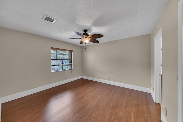 unfurnished room featuring hardwood / wood-style flooring, ceiling fan, and a textured ceiling