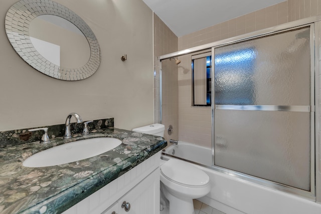 full bathroom featuring vanity, toilet, and combined bath / shower with glass door