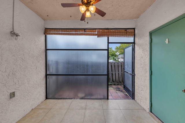 kitchen with light tile patterned floors and ceiling fan