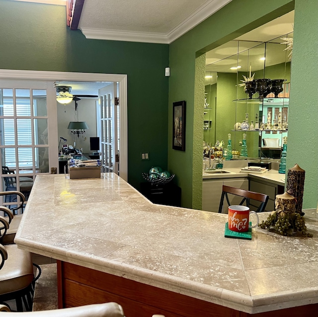 kitchen featuring ornamental molding and sink