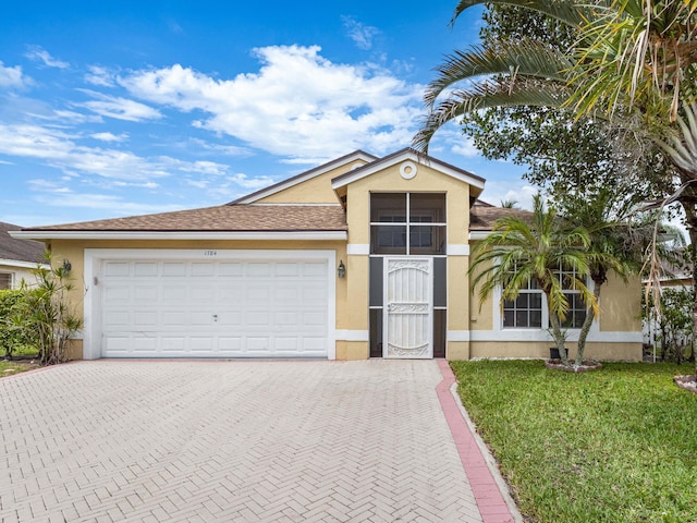 1784 Sawgrass Cir, Greenacres, FL 33413 - single story home with stucco siding, decorative driveway, an attached garage, and a front lawn