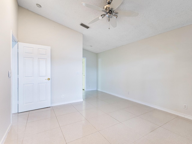 1784 Sawgrass Cir, Greenacres, FL 33413 - spare room with ceiling fan, a textured ceiling, baseboards, light tile patterned flooring, and lofted ceiling