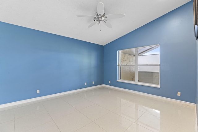 tiled empty room featuring ceiling fan and lofted ceiling