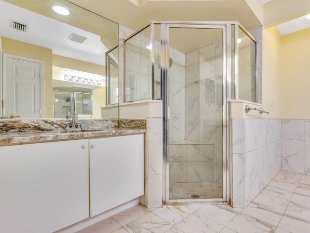 bathroom with walk in shower and vanity