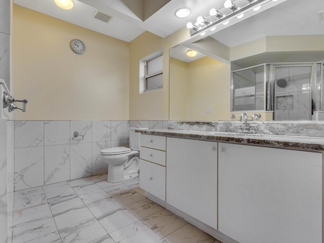 bathroom with toilet, tile walls, walk in shower, and vanity