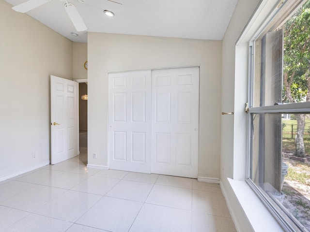 1784 Sawgrass Cir, Greenacres, FL 33413 - unfurnished bedroom with lofted ceiling, baseboards, light tile patterned flooring, and a closet