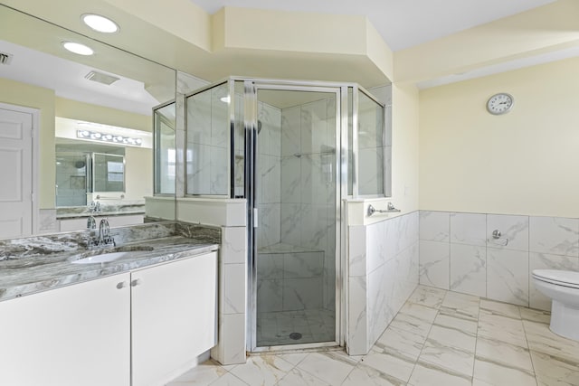 bathroom with a shower with shower door, tile walls, toilet, and vanity