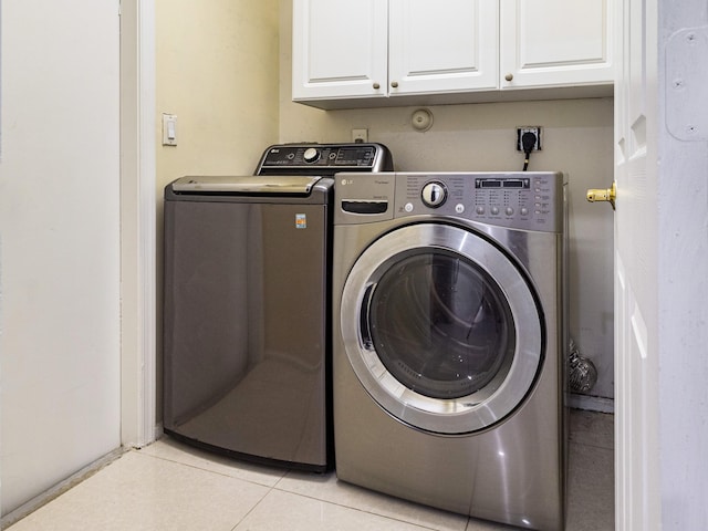 1784 Sawgrass Cir, Greenacres, FL 33413 - clothes washing area featuring washer and dryer, cabinet space, and light tile patterned floors