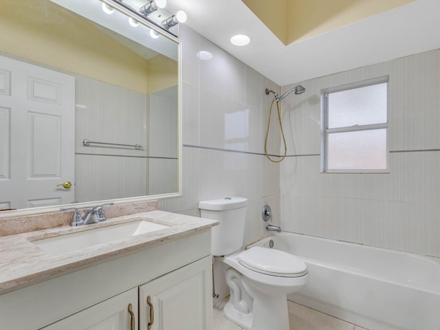 full bathroom with toilet, vanity, tiled shower / bath, and tile patterned flooring