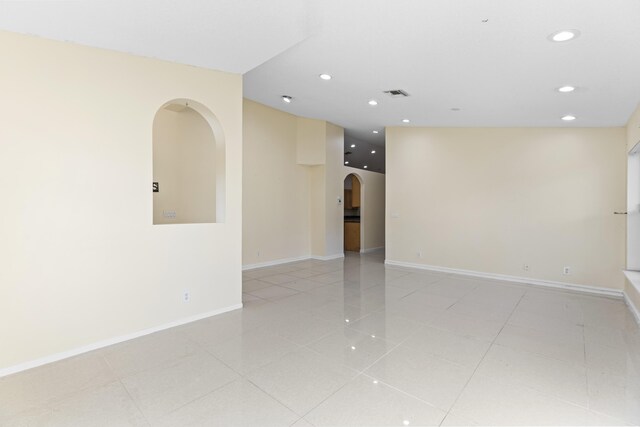 1784 Sawgrass Cir, Greenacres, FL 33413 - unfurnished room featuring arched walkways, light tile patterned floors, recessed lighting, and baseboards