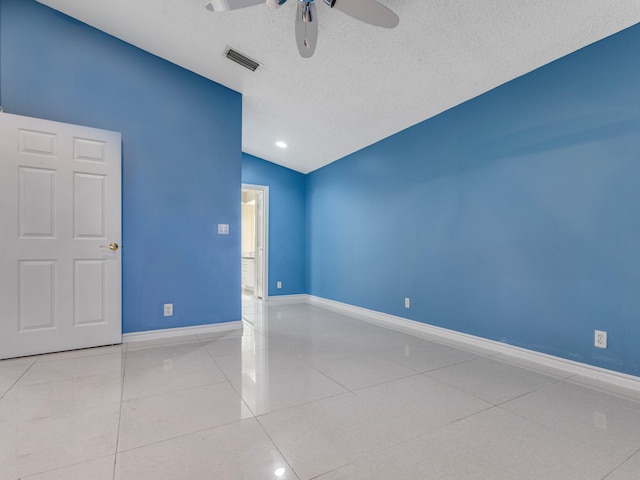 unfurnished room featuring ceiling fan, a textured ceiling, light tile patterned floors, and lofted ceiling