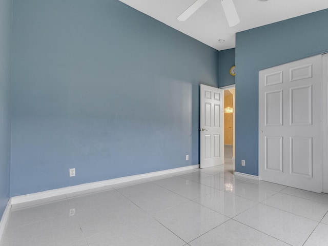 unfurnished bedroom featuring ceiling fan and light tile patterned flooring