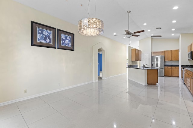 1784 Sawgrass Cir, Greenacres, FL 33413 - unfurnished living room with ceiling fan, lofted ceiling, baseboards, a sink, and arched walkways