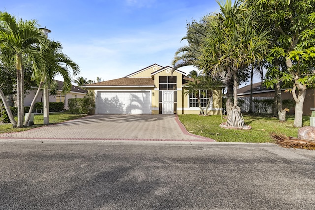 view of front facade with a garage and a front lawn