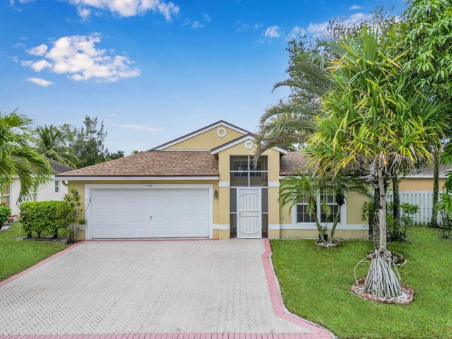 1784 Sawgrass Cir, Greenacres, FL 33413 - ranch-style house with stucco siding, a garage, decorative driveway, and a shingled roof