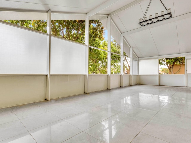 unfurnished sunroom with vaulted ceiling