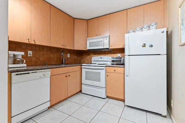 kitchen featuring light tile patterned floors, sink, decorative backsplash, and white appliances