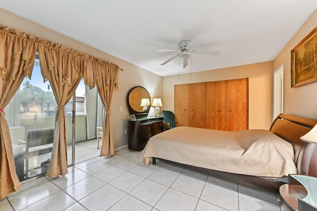 bedroom featuring ceiling fan, a closet, and light tile patterned flooring