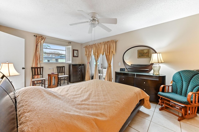 tiled bedroom featuring ceiling fan and a textured ceiling