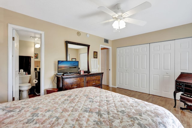 bedroom with ceiling fan, ensuite bath, and light hardwood / wood-style flooring