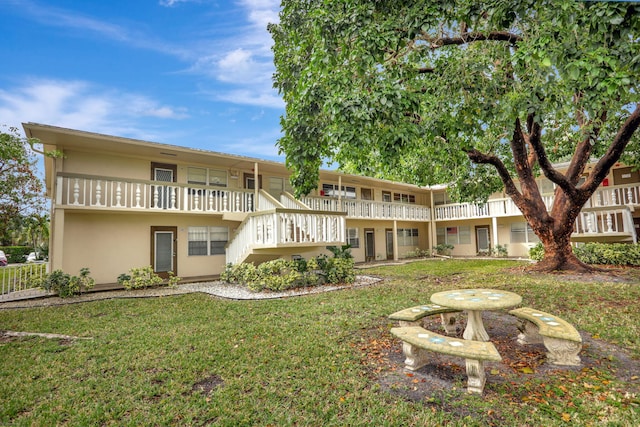 rear view of property with a yard