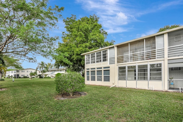 back of house featuring a lawn