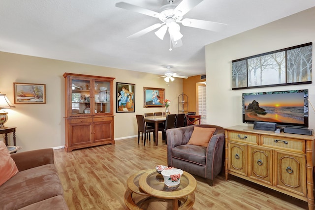 living room featuring light hardwood / wood-style floors and ceiling fan