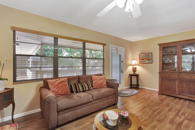 living room featuring light hardwood / wood-style flooring and ceiling fan