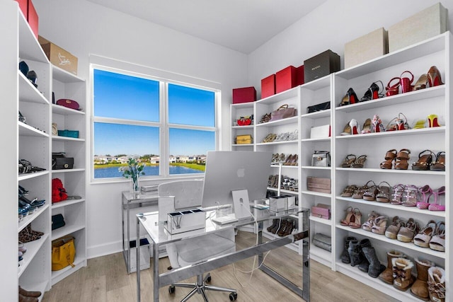 home office with light hardwood / wood-style flooring