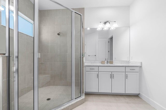 bathroom featuring an enclosed shower, vanity, and tile patterned floors