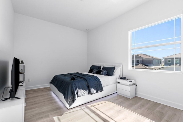 bedroom with light hardwood / wood-style floors