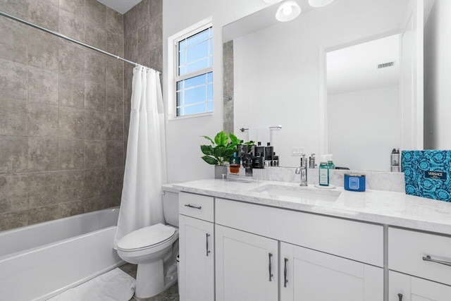 full bathroom featuring toilet, shower / bath combo with shower curtain, and vanity