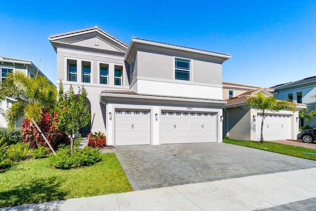 view of front of home featuring a front lawn and a garage