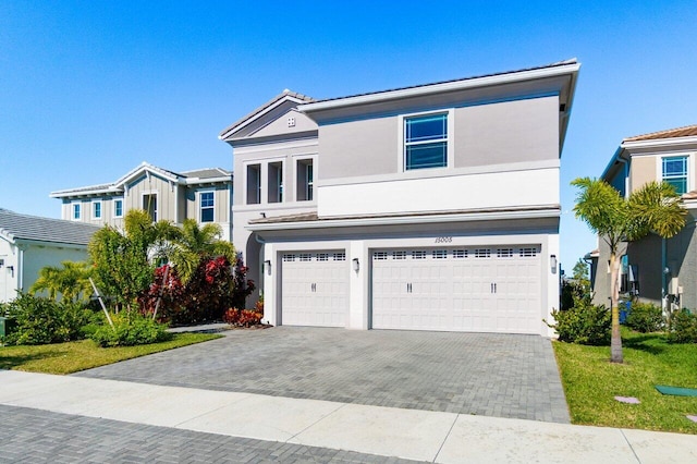 view of front of house featuring a front lawn and a garage