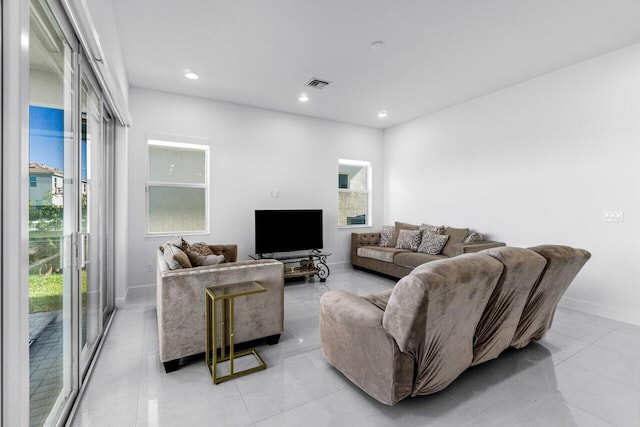 living room featuring a wealth of natural light and light tile patterned floors