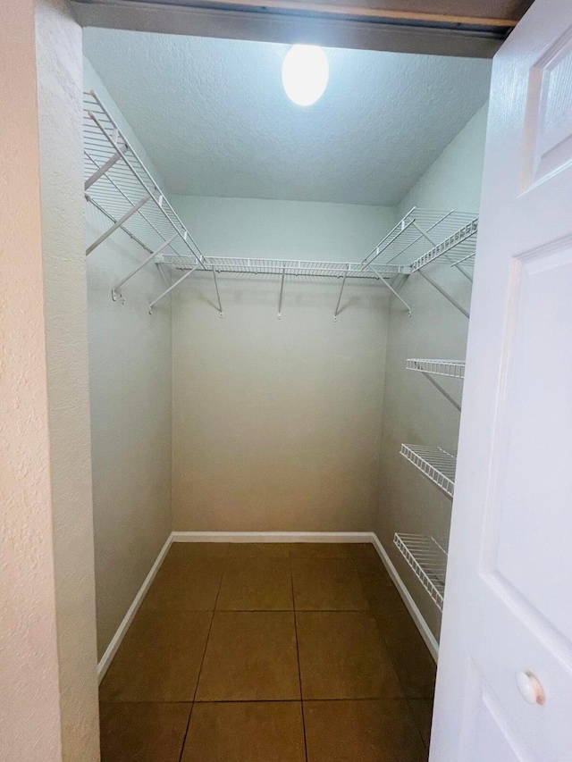 walk in closet featuring tile patterned flooring