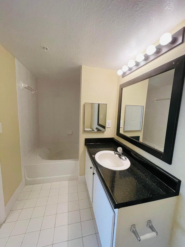 bathroom featuring vanity, tile patterned floors, a textured ceiling, and  shower combination