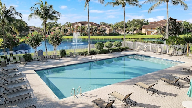 view of pool featuring a patio area and a water view