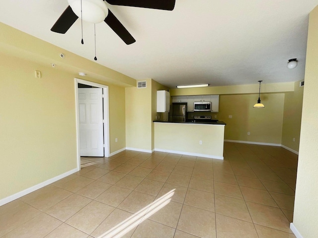 unfurnished living room with light tile patterned flooring and ceiling fan