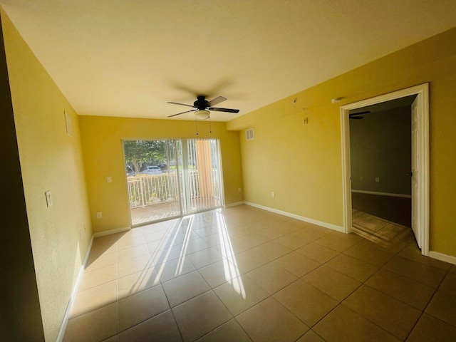 empty room with ceiling fan and light tile patterned flooring