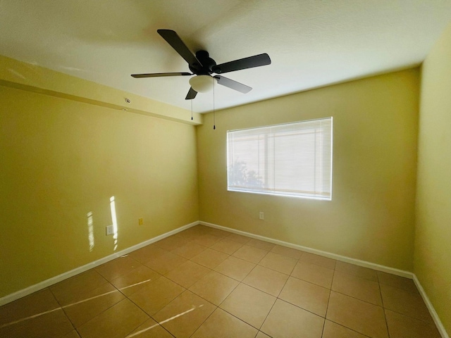 tiled empty room with ceiling fan