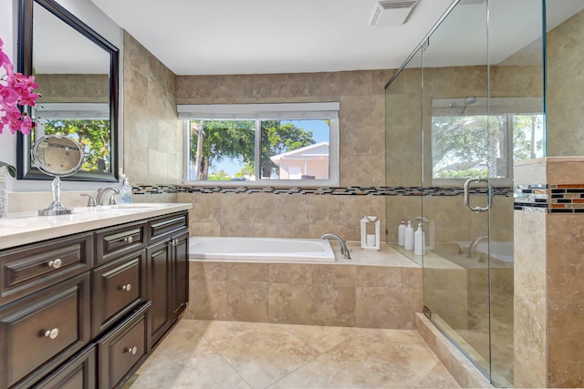 bathroom with tile walls, plus walk in shower, tile patterned floors, and vanity