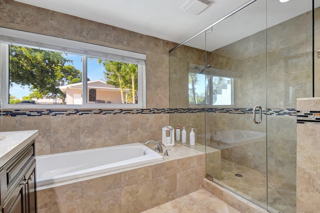 bathroom featuring shower with separate bathtub, vanity, and tile patterned flooring