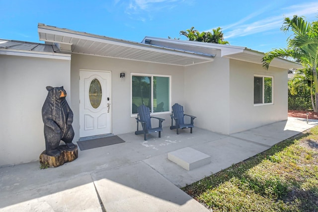 property entrance featuring a patio