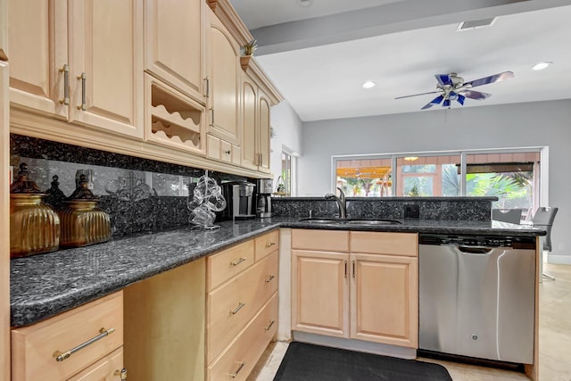 kitchen featuring dishwasher, dark stone counters, light brown cabinets, sink, and backsplash