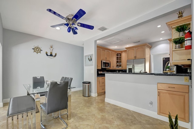 kitchen featuring stainless steel appliances, ceiling fan, light tile patterned floors, kitchen peninsula, and light brown cabinetry