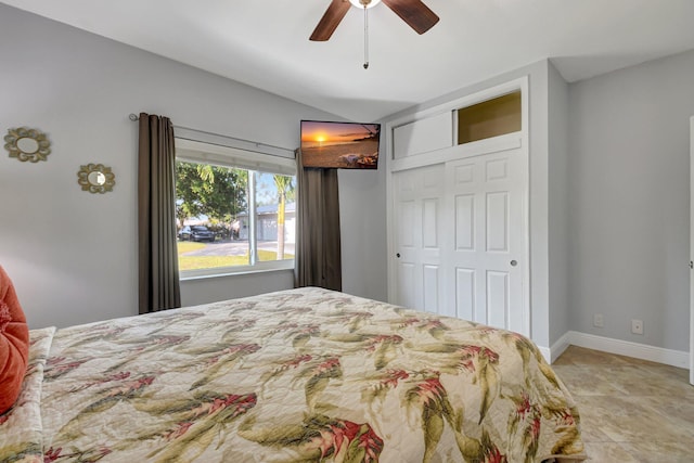 bedroom with lofted ceiling, ceiling fan, and a closet